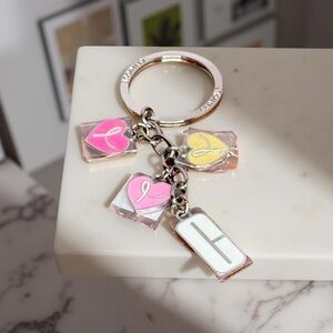 Unique Clinique keychain in silver tone metal NWT.  Can be used as a charm.